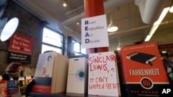 FILE - Books are displayed under a sign at Harvard Book Store, March 9, 2017, in Cambridge, Mass.