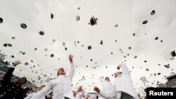 Graduates toss their hats after receiving their diplomas at the graduation and commissioning ceremony for the U.S. Naval Academy&#39;s Class of 2021, at the U.S. Naval Academy in Annapolis, Maryland.