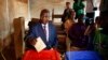 FILE - Former Prime Minister Faustin Archange Touadera casts his ballot in the second round of presidential election and the first round of legislative elections in Bangui, Central African Republic, Feb. 14, 2016. Touadera was declared winner of the election Feb. 20.