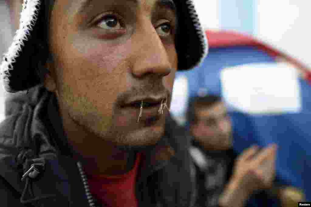 Yosri Adjili, 25, who is unemployed, goes on a hunger strike with his mouth sewed shut during a sit-in protest to get jobs, at the local government office courtyard in Kasserine, Tunisia.