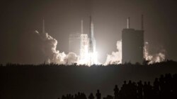 A Long March 5 rocket carrying China's Chang'e-5 lunar probe launches from the Wenchang Space Center on China's southern Hainan Island on November 24, 2020, on a mission to bring back lunar rocks. (AFP)