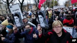 Protesters gather outside Poland's Constitutional Tribunal in Warsaw, Nov. 6, 2021, rallying against restrictive abortion laws after a woman died of complications during her pregnancy. 