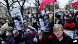 File - Protesters gather in Warsaw, Nov. 6, 2021, rallying against restrictive abortion laws after a woman died of complications during her pregnancy. Poland's government has been accused of creating a "pregnancy register" by expanding the medical data being saved on patients. 