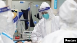 武汉中心医院医护人员正在救治患者。（2020年1月25日）