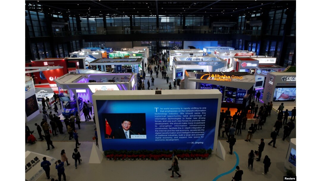 FILE - China's President Xi Jinping is shown on a screen in front of logos of China's leading internet companies during the World Internet Conference in Wuzhen town of Jiaxing, Zhejiang province, China, Nov. 17, 2016.