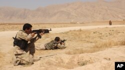 Afghanistan's security forces take their position during a clash by Taliban fighters in the highway between Balkh province to Kunduz city, north of Kabul, Afghanistan, Sept. 1, 2015. 