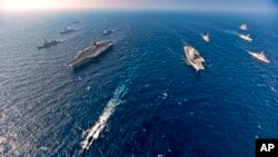 Aircraft carriers and warships participate in the second phase of Malabar naval exercise, a joint exercise comprising of India, US, Japan and Australia, in the Northern Arabian Sea on Tuesday, Nov. 17, 2020. 