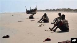 In this image released by UNHCR, unidentified refugees rest on an undisclosed beach in Yemen in March 2007. Many Ethiopians and Somalis hire smugglers to get them to Yemen. However, many are robbed, abused and some even thrown overboard. 