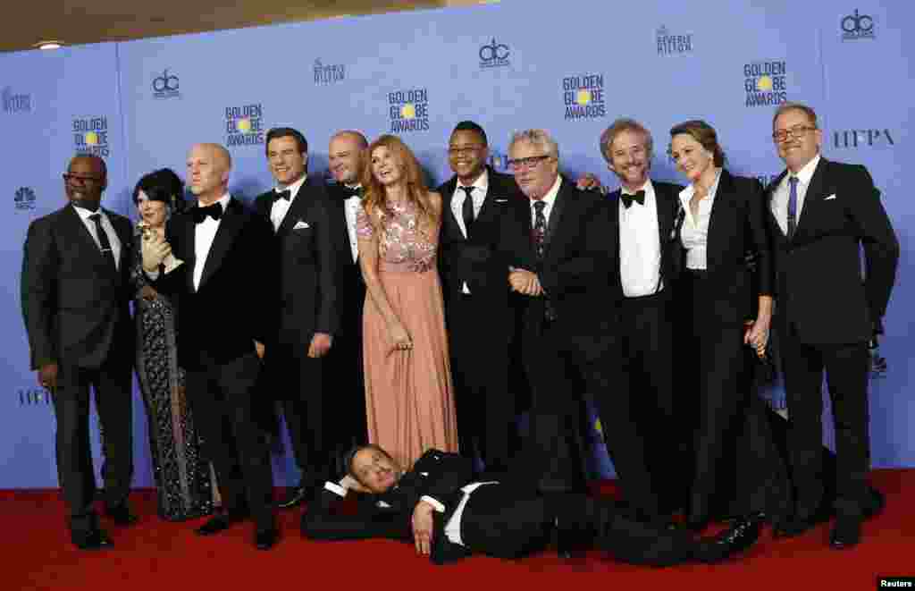 The cast and producers of "The People v. O.J. Simpson: American Crime Story" including Courtney B. Vance (L), producer Ryan Murphy (3rd L), actor John Travolta (4th L), Connie Britton (C) and Cuba Gooding Jr (5th R), pose with their award for Best Televis