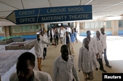 FILE - Kenyan student doctors walk towards the labor wards at the Kenyatta National Hospital during a doctors' strike in Nairobi, Kenya, Jan. 19, 2017.