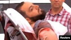 A still image captured from a video from WABC television shows a conscious man believed to be New York bombing suspect Ahmad Khan Rahami being loaded into an ambulance after a shoot-out with police in Linden, New Jersey, U.S., September 19, 2016. Courtesy WABC-TV via REUTERS