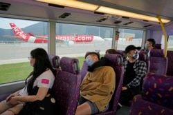 Penumpang duduk di dek atas bus tingkat selama tur di Hong Kong, Sabtu, 16 Oktober 2021. (Foto: AP)