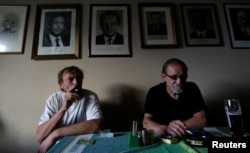 Men smoke cigarettes in a pub on a last day before a smoking ban comes into effect in Prague, Czech Republic, May 30, 2017.