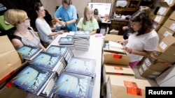 Employees unbox "Go Set A Watchman" at Ol' Curiosities & Book Shoppe in Monroeville, Alabama July 14, 2015.