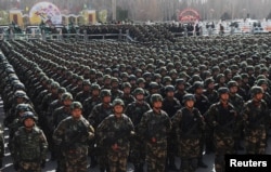 Paramilitary policemen stand in formation as they take part in an anti-terrorism oath-taking rally, in Kashgar, Xinjiang Uighur Autonomous Region, China, Feb. 27, 2017.