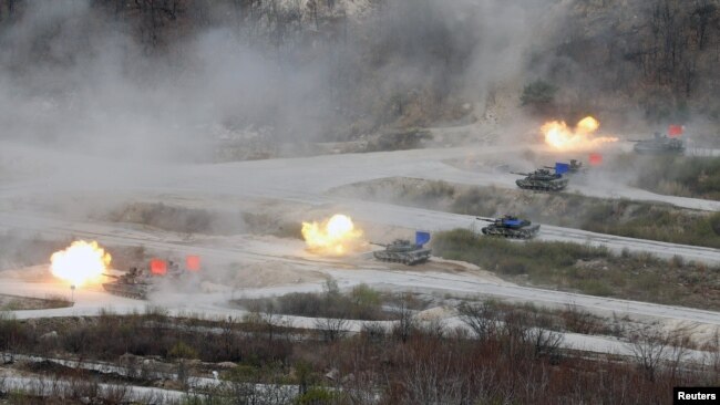 FILE - South Korean Army K1A1 and U.S. Army M1A2 tanks fire live rounds during a U.S.-South Korea joint live-fire military exercise, at a training field near the demilitarized zone separating the two Koreas in Pocheon, South Korea, April 21, 2017.