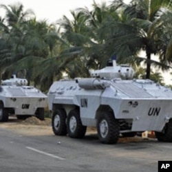 UN armored personnel carriers (APC) park near the Gulf Hotel