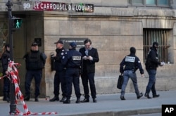 Police officers cordon off the area outside the Louvre museum near where a soldier opened fire after he was attacked in Paris, Feb. 3, 2017.