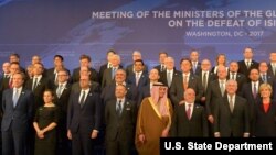 FILE - U.S. Secretary of State Rex Tillerson poses for a family photo with counterparts at the Meeting of the Ministers of the Global Coalition on the Defeat of ISIS in Washington, D.C.