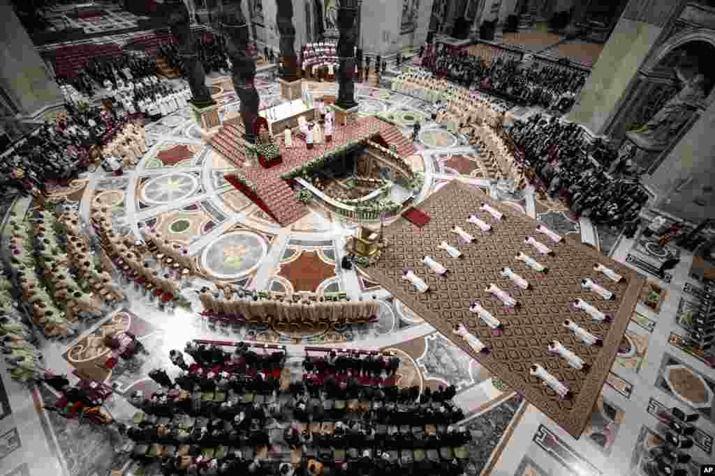Priests lie face down on the floor during an ordination ceremony presided over by Pope Francis, in St. Peter&#39;s Basilica at the Vatican.