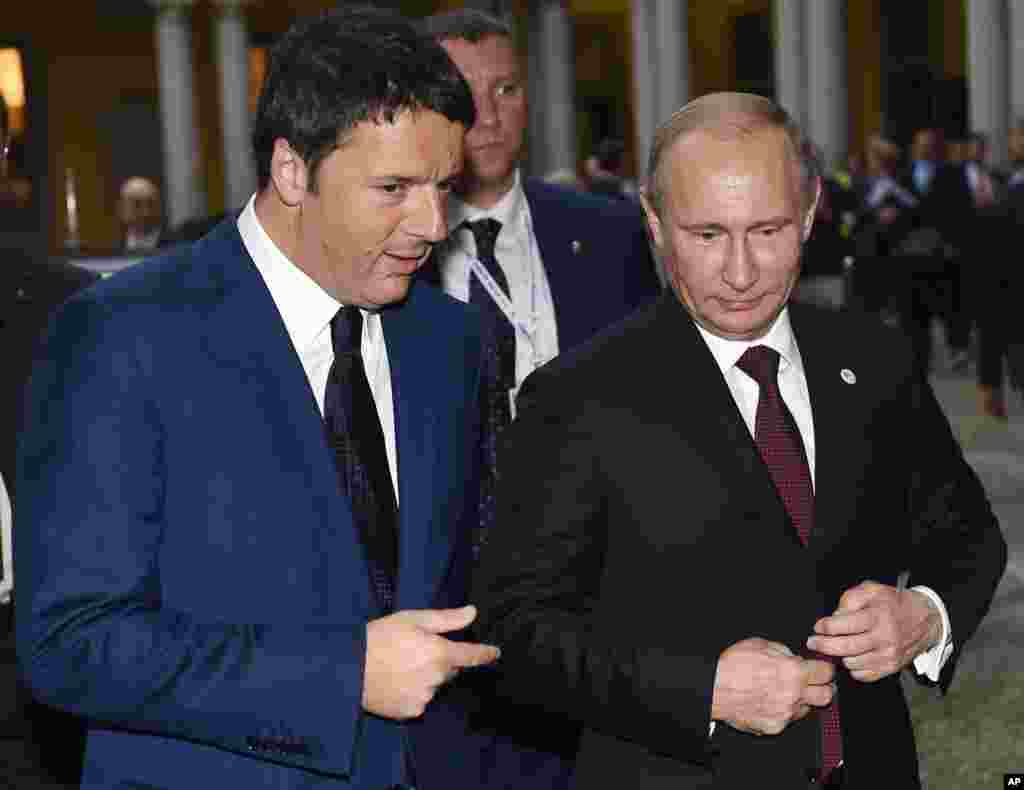 Italian Prime Minister Matteo Renzi, left, talks with Russian President Vladimir Putin during a meeting on the sidelines of the ASEM summit of European and Asian leaders in Milan, Oct. 17, 2014.