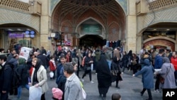 FILE - People walk around the Grand Bazaar in Tehran, Iran, Feb. 7, 2019.