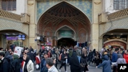 FILE - People walk around the Grand Bazaar in Tehran, Iran, Feb. 7, 2019.