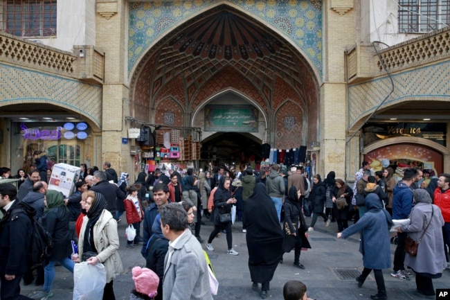 FILE - People walk around the Grand Bazaar in Tehran, Iran, Feb. 7, 2019. Description: In this Thursday, Feb. 7, 2019, photo, people walk around the Grand Bazaar in Tehran, Iran. The economy faces multiple struggles as the country marks the 40th anniversary of the Islamic Revolution.