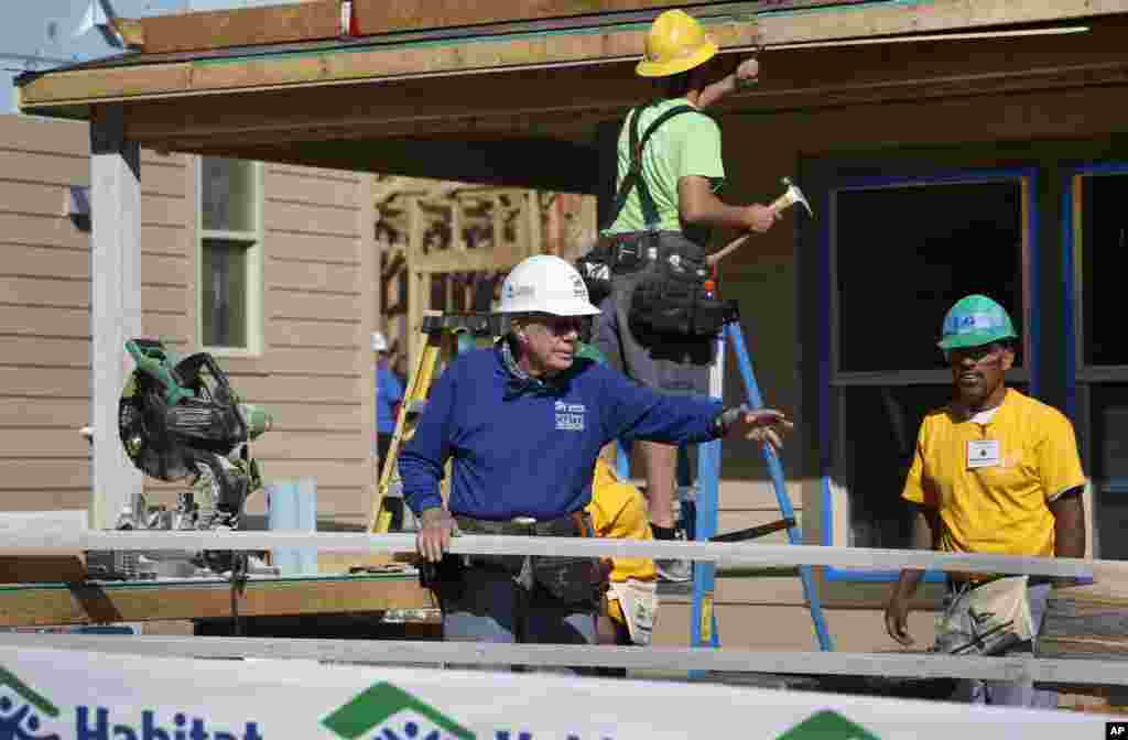 Former President Jimmy Carter helps cut wood for home construction at a Habitat for Humanity construction site in the Globeville neighborhood of Denver, Wednesday Oct. 9, 2013.