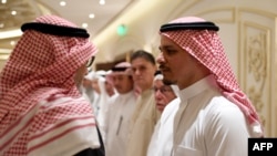 FILE - Salah Khashoggi, right, the son of murdered Saudi journalist Jamal Khashoggi, and his relatives receive mourners at an events hall in the Saudi coastal city of Jeddah, Nov. 16, 2018.