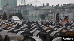 Rolls of steel are moved outside the ArcelorMittal Dofasco plant, an integrated steel producer, in Hamilton, Ontario, Canada, March 7, 2018. 