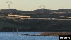 FILE - Dakota Access Pipeline equipment is seen near Lake Oahe, near the Standing Rock Indian Reservation, in this picture taken from across the Missouri River in Linton, North Dakota, Nov. 9, 2016.