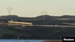 Dakota Access Pipeline equipment is seen near Lake Oahe, near the Standing Rock Indian Reservation, in this picture taken from across the Missouri River in Linton, North Dakota, Nov. 9, 2016.