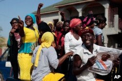Gambians celebrate the victory of opposition coalition candidate Adama Barrow against longtime President Yahya Jammeh in the streets of Serrekunda, Gambia, Dec. 2, 2016.