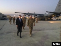 U.S. Sen. John McCain of Arizona walks with American service personnel as an EC-130H Compass Call, deployed from a base in his home state of Arizona, is prepared for a mission.