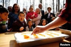New Canadian citizen David Alfonso, 8, reacts as maple taffy is prepared for new Canadians following a citizenship ceremony at the Vanier Sugar Shack in Ottawa, Ontario, Canada, April 11, 2018.