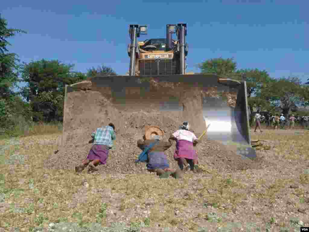 Villagers in northern Myanmar lay in front of a bulldozer as part of their bid to stop the controversial expansion of the Chinese-backed Letpadaung Copper Mine, Dec. 22, 2014. (photographer unknown)