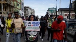 Des gens brandissent des banderoles alors qu'ils manifestent dans la rue pour protester contre la brutalité policière à Lagos, au Nigeria, le samedi 17 octobre 2020.