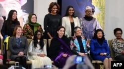 First Lady Michelle Obama, back row, center, poses with recipients of the Secretary of State’s International Women of Courage Award, Washington, March 4, 2014.