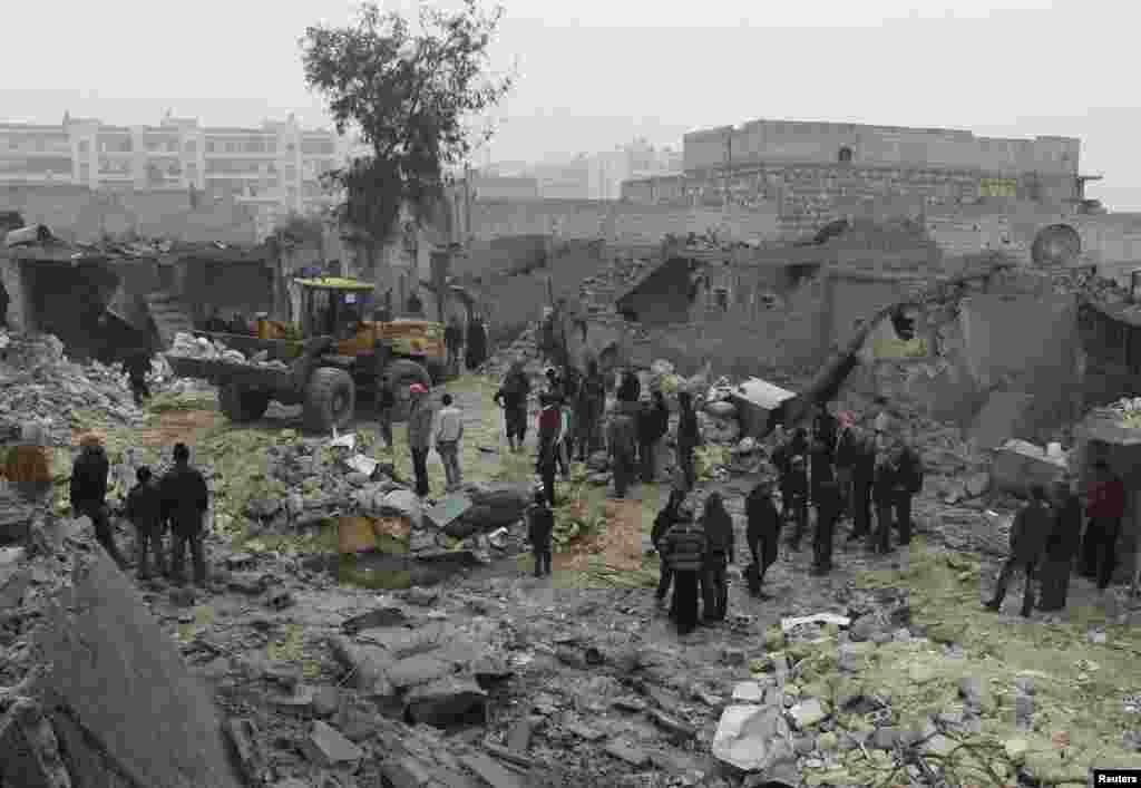 Civilians gather after what they said was shelling by forces loyal to Syrian President Bashar al-Assad, Jazmati, Aleppo, Jan. 23, 2014. 