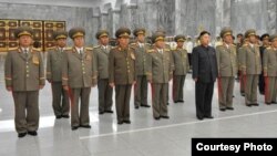 North Korea defense commission vice chairman Jang Song Taek is seen in a dark brown uniform third from left in the first row at a ceremony in Pyongyang, September 9, 2012. (Rodong Sinmun photo) 