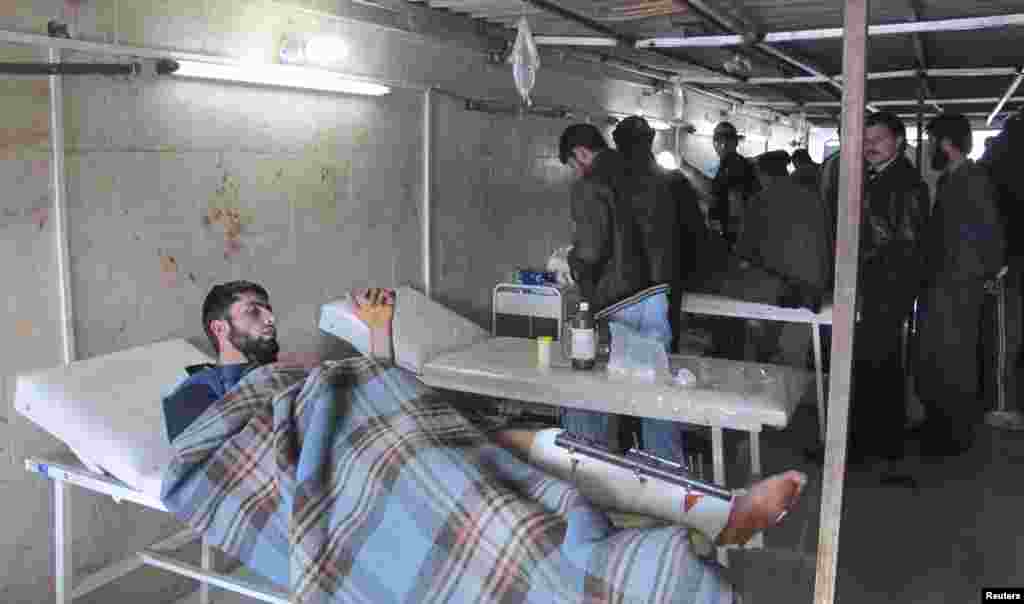 Free Syrian Army fighters, wounded during the battle to capture Taftanaz air base, receive treatment at a field hospital in northern Idlib, Syria, January 6, 2013. 