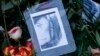 A photograph of Tugce Albayrak is placed among flowers on her grave at a cemetery in Bad Soden-Salmuenster, Dec. 3, 2014. 