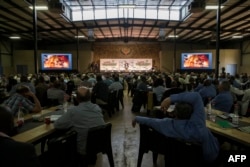 Farmers, politicians and key role players in the agriculture sector listen to South Africa Deputy President David Mabuza speak as they attend AgriSA, a South African agricultural industry association, at a conference titled "The Land Solution" on the Zwartkloof Private Game Reserve in Bela Bela, Aug. 23, 2018.