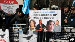 FILE - Uighurs and their supporters rally across the street from United Nations headquarters in New York, March 15, 2018.