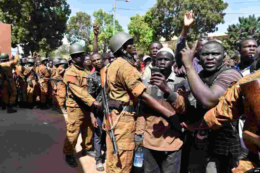 A crowd gathers in front of army headquarters in Ouagadougou, demanding that the army take over following the resignation of the president. Burkina Faso's army chief Navere Honore Traore said he was taking power on October 31 as head of state. 