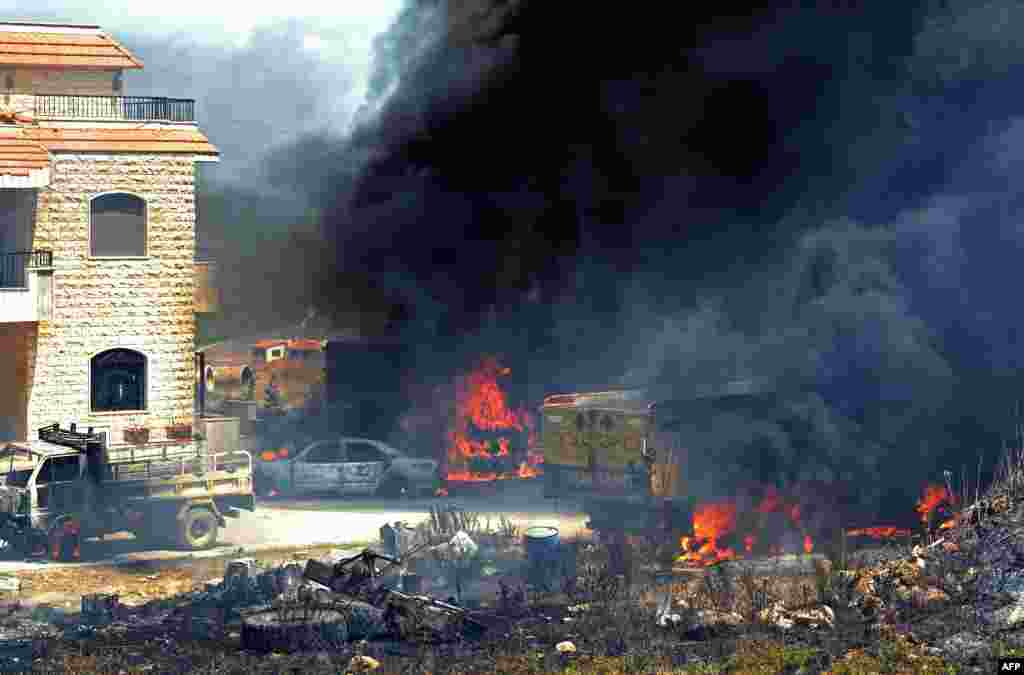 Vehicles burn outside a home after a fuel tank exploded in the village of Tlel in Lebanon's northern region of Akkar. At least 20 people were killed and nearly 80 others injured when the fuel tank exploded.