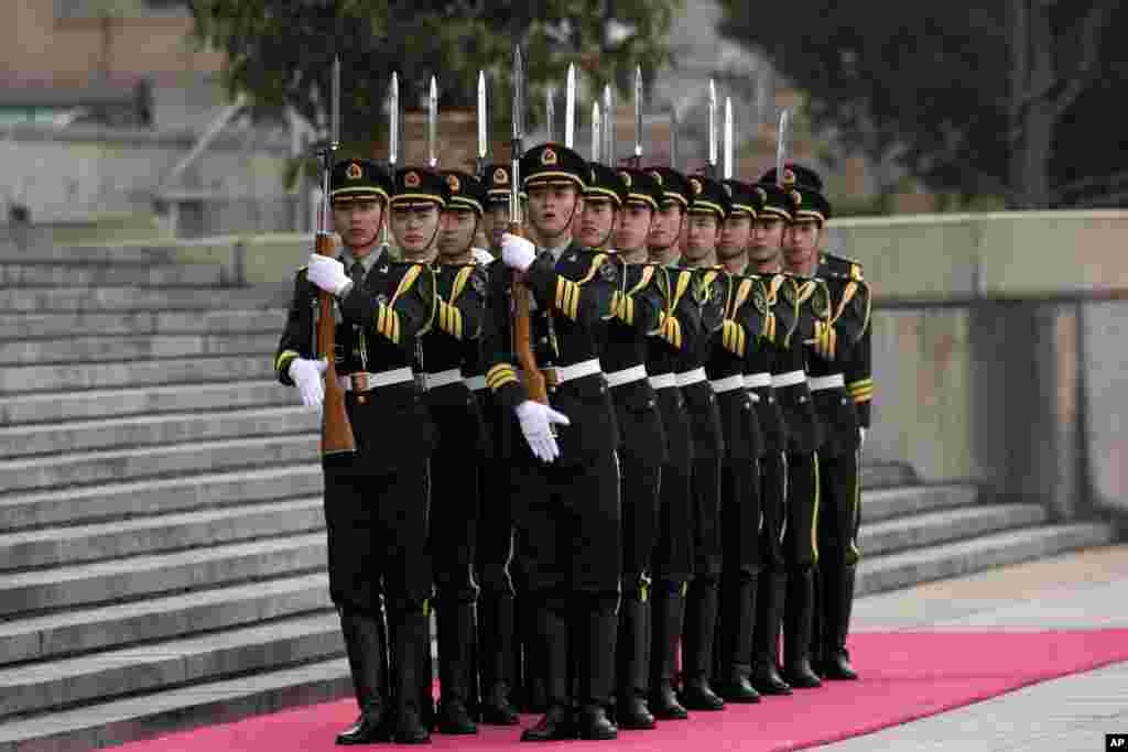 Members of a Chinese guard of honor march off outside the Great Hall of the People in Beijing after a welcome ceremony of Sri Lankan President Mahinda Rajapaksa. 