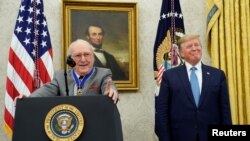 U.S. President Donald Trump smiles after presenting the Presidential Medal of Freedom to Boston Celtics legend and Basketball Hall of Famer Bob Cousy in the Oval Office of the White House, Aug. 22, 2019.