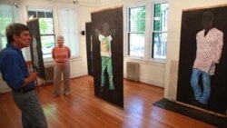 Visitors looking at Judy Byron's "Perfect Girls" exhibit